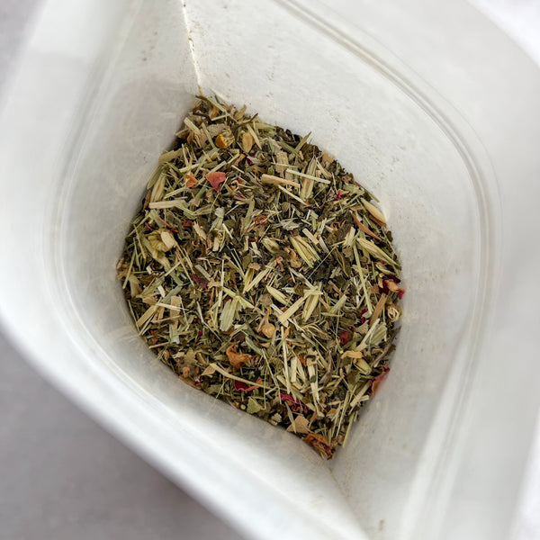 Tea bag with dry herbs and spices on a white background